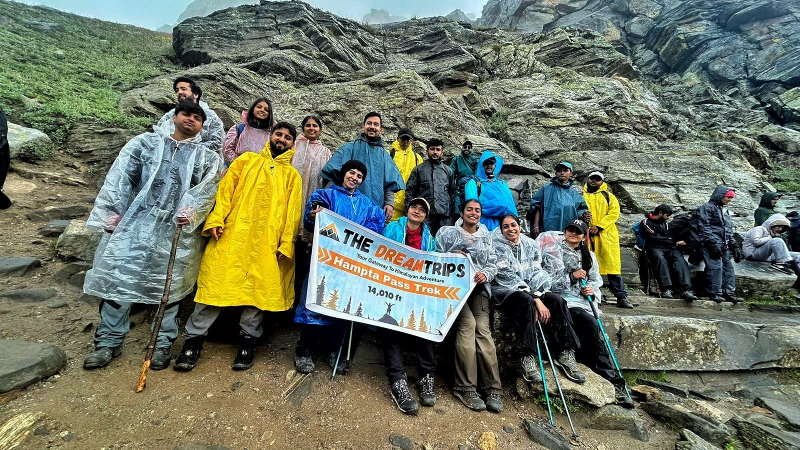 Trekker standing at Hampta Pass summit with panoramic view of Lahaul valley – 2025